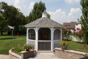 A white gazebo surrounded by grass
